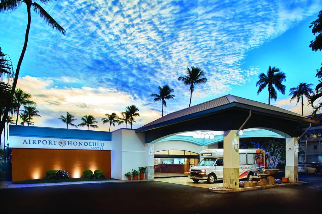 A facade of a building with a sign that says Airport Honolulu Hotel.