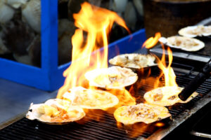 Baked cheese scallops grilled in a street cart in Seoul.
