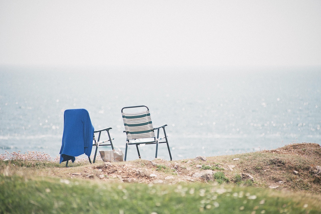 A beach towel hanging on the beach chair at the beach