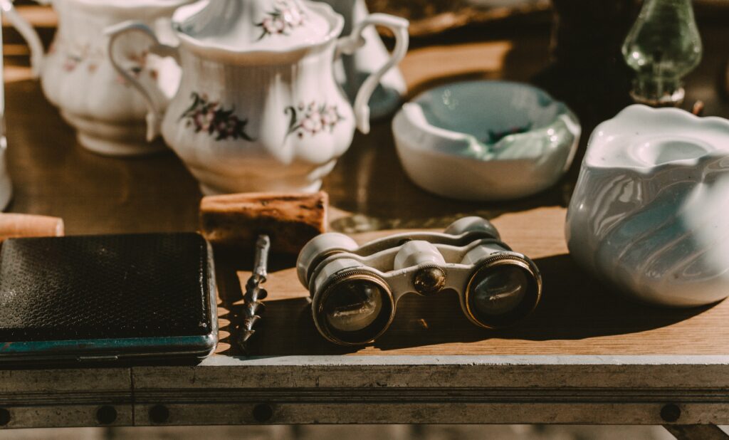 Gray binocular with old ceramics behind.