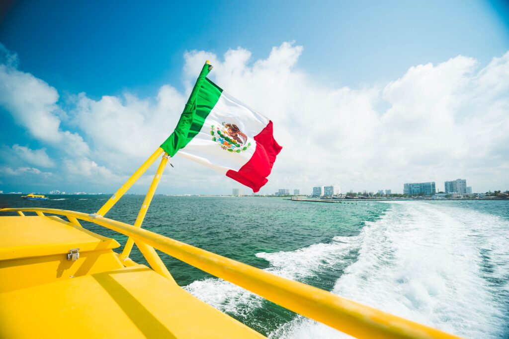 Mexican flag raised in the yellow boat.