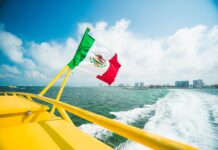 Mexican flag raised in the yellow boat.