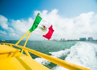 Mexican flag raised in the yellow boat.