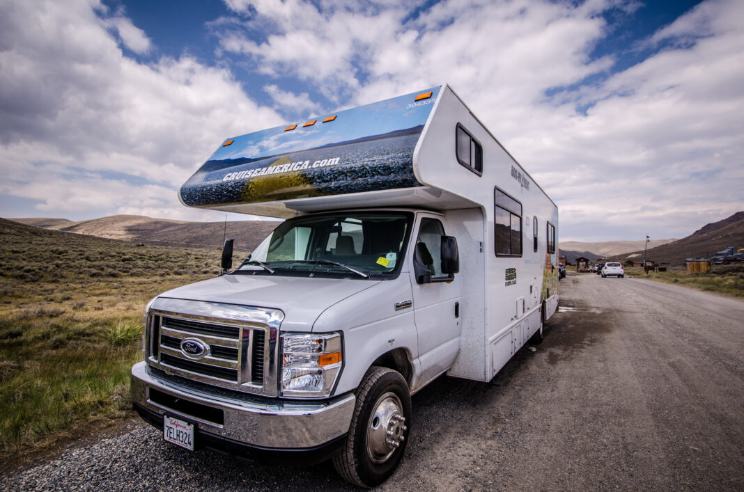 A Cruise America RV recreational vehicle is parked in Bodie Ghost Town. These cars are rental RVs for tourists, and popular in the Western United States