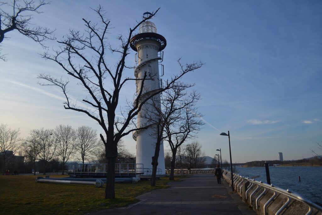 A beacon tower behind trees in Danube Island