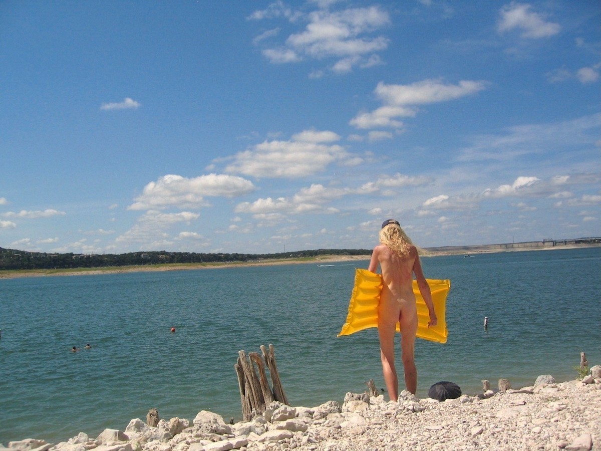 Women carrying a water float in Hippie Hollow Park 