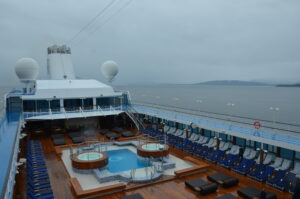 View of the ocean from the deck of a ship.