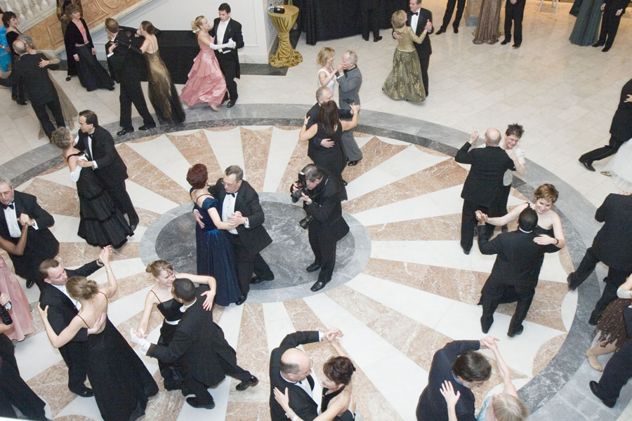 People dancing waltz in a ballroom.