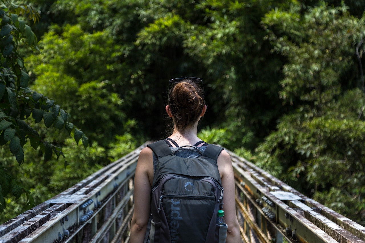 Women backpacker jungle trekking in the forest