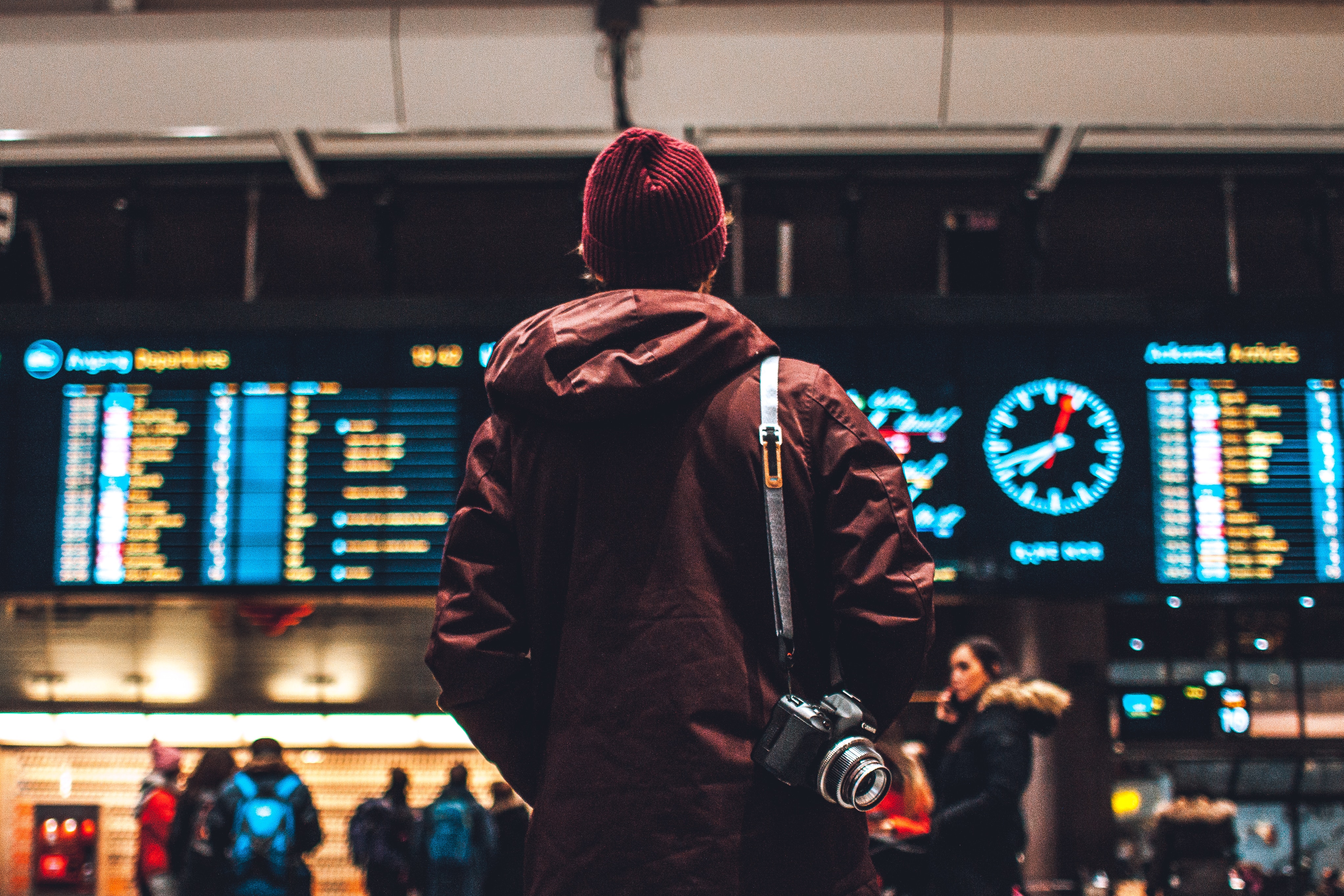 Traveler at an airport checking his flight boarding time