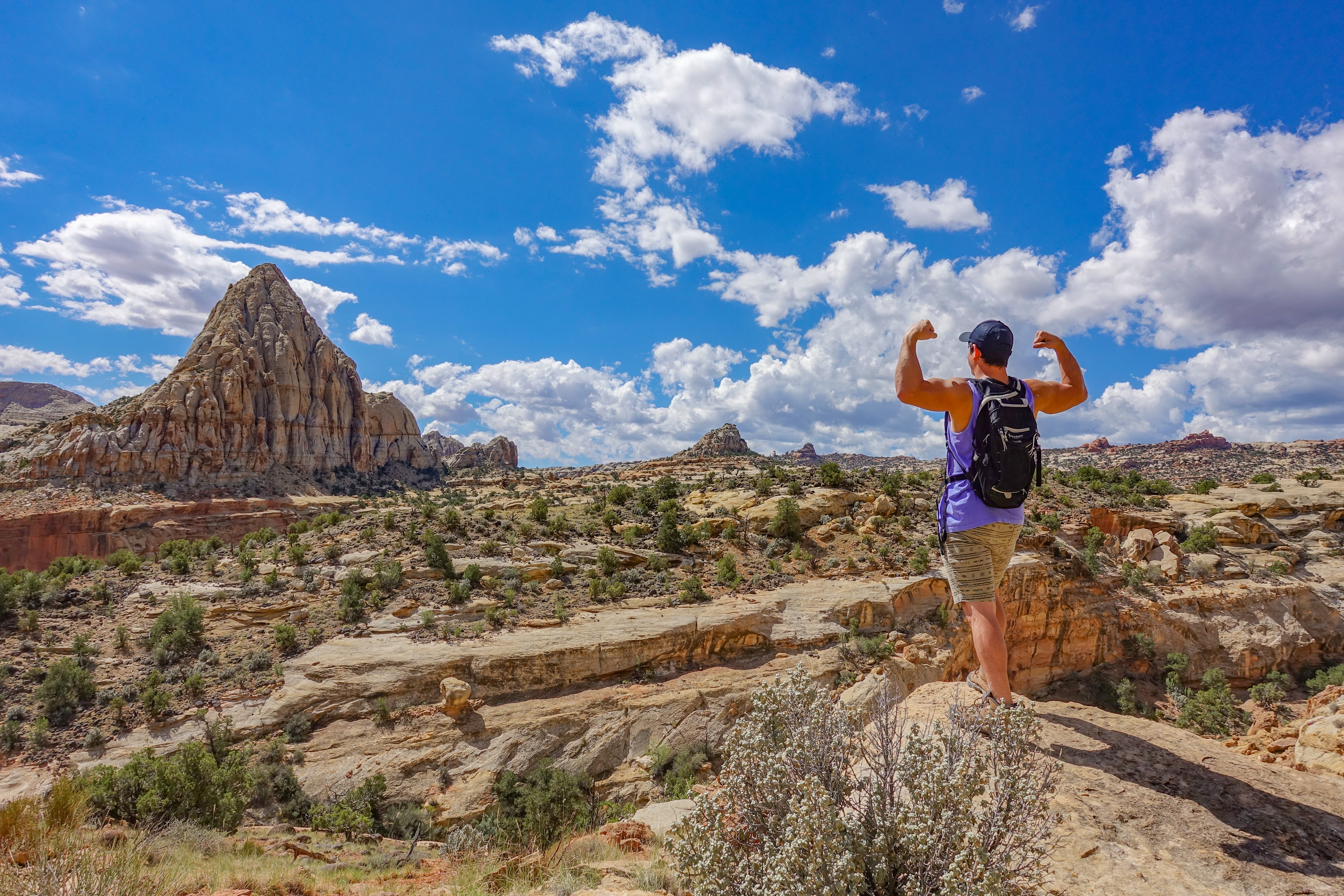 man conquering the hike at Capitol Reef National Park