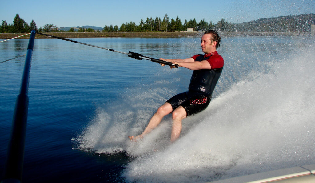 A guy skiing barefooted.