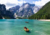 Hikers and travelers sailing boat in Lake braies, Dolomite, Italy.