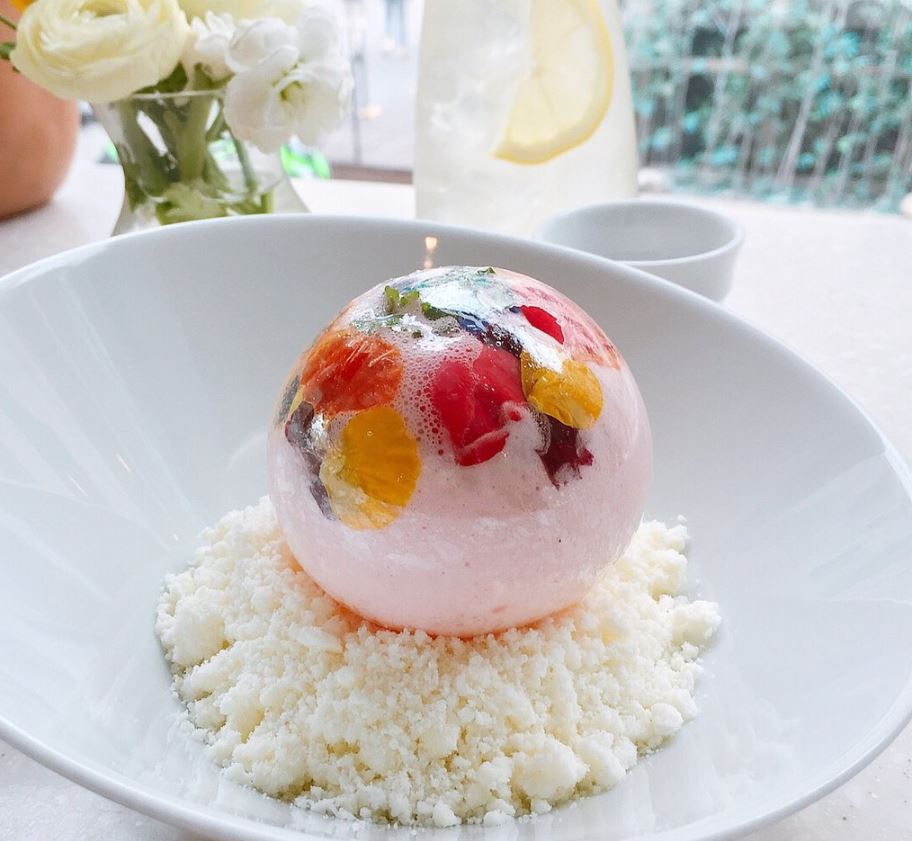 A pink sugar ball in a white bowl.