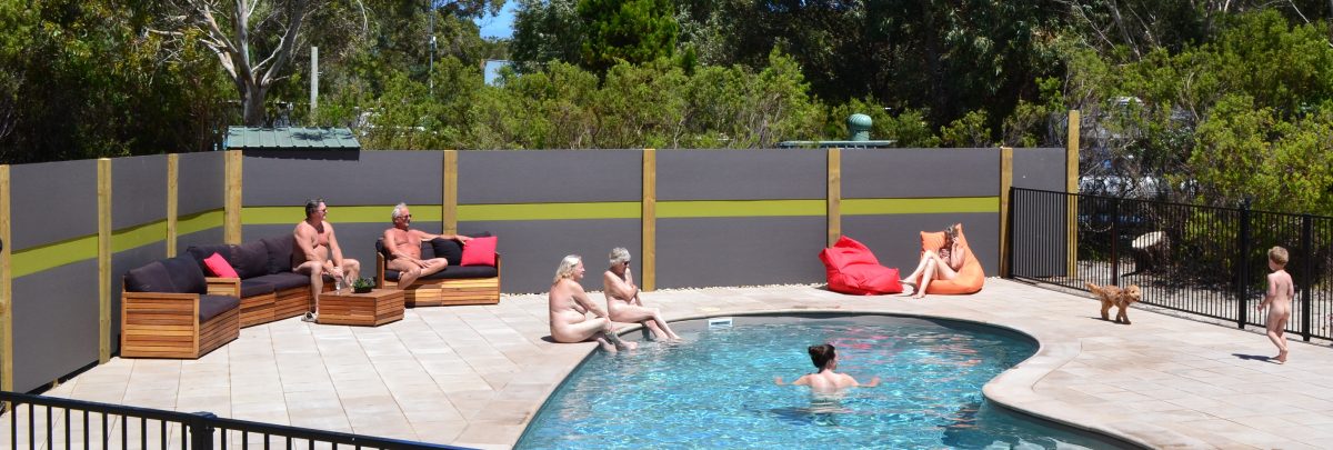 Nude tourist having a family activity near the pool in Sunland Holiday Village, Australia