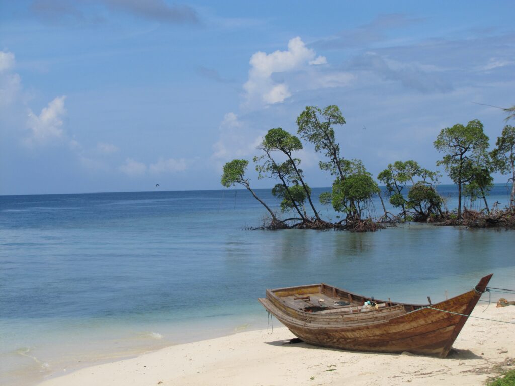 A small boat on the sea shore.