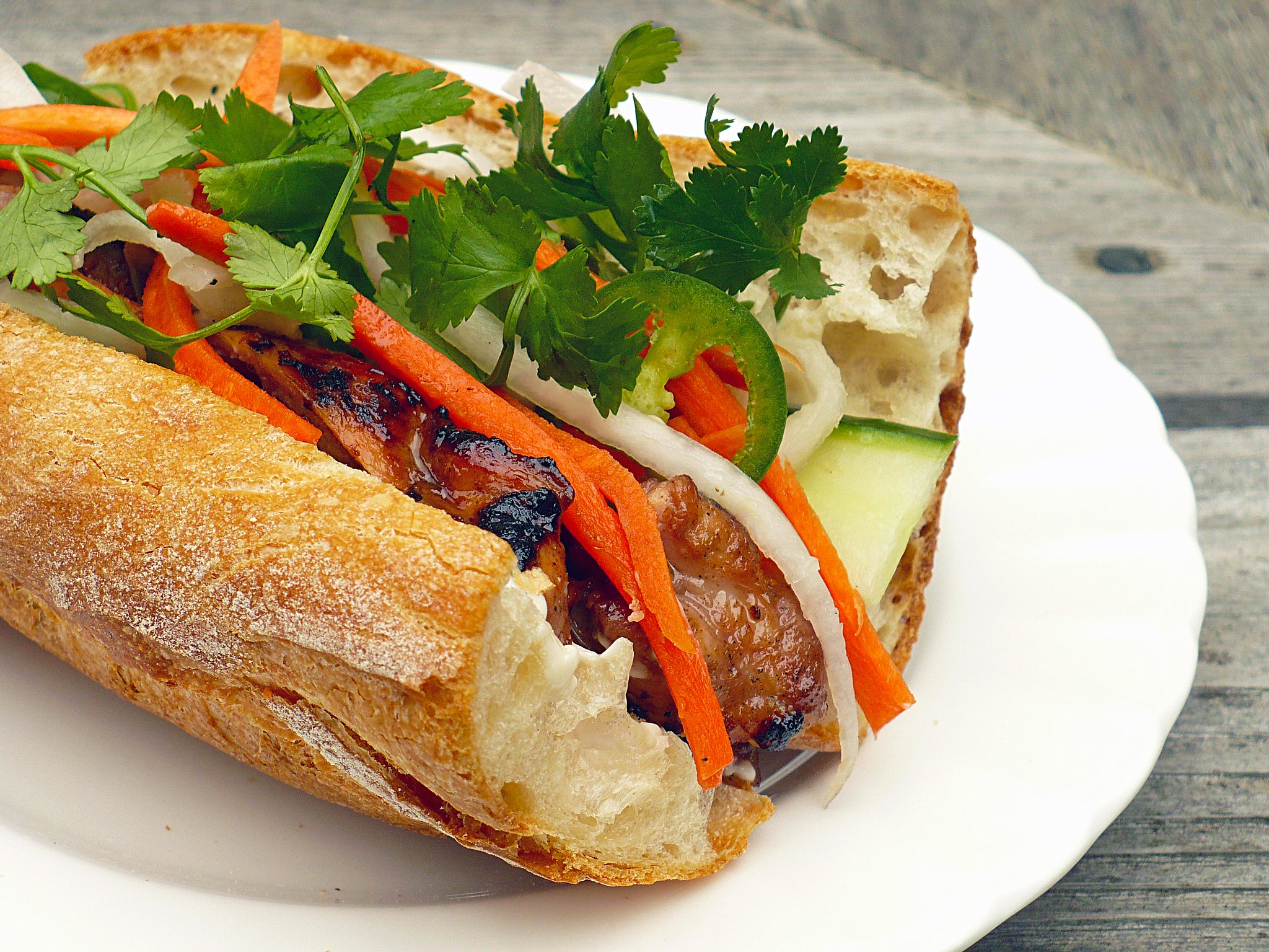 Vietnamese most popular street food is Banh Mi with roasted pork filling with Vietnamese coriander and herbs