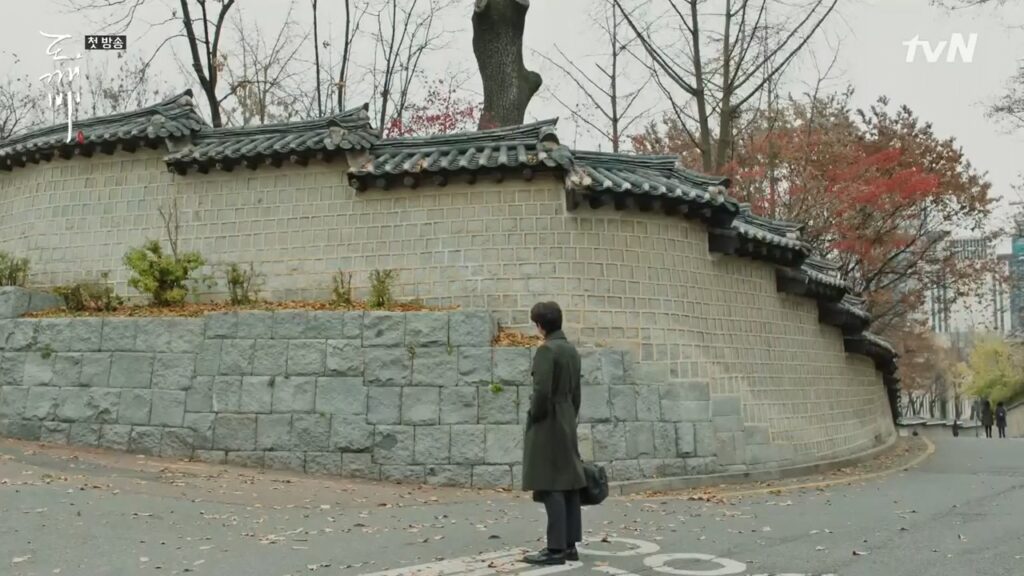 A man staring at a stone wall.