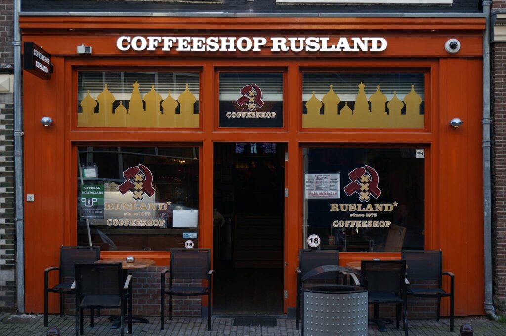 A brown store front with a signage above that says "Coffeeshop Rusland".