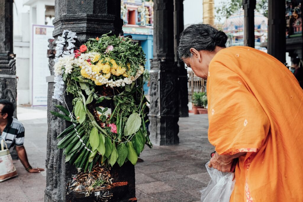 A woman praying inside a temple in India.