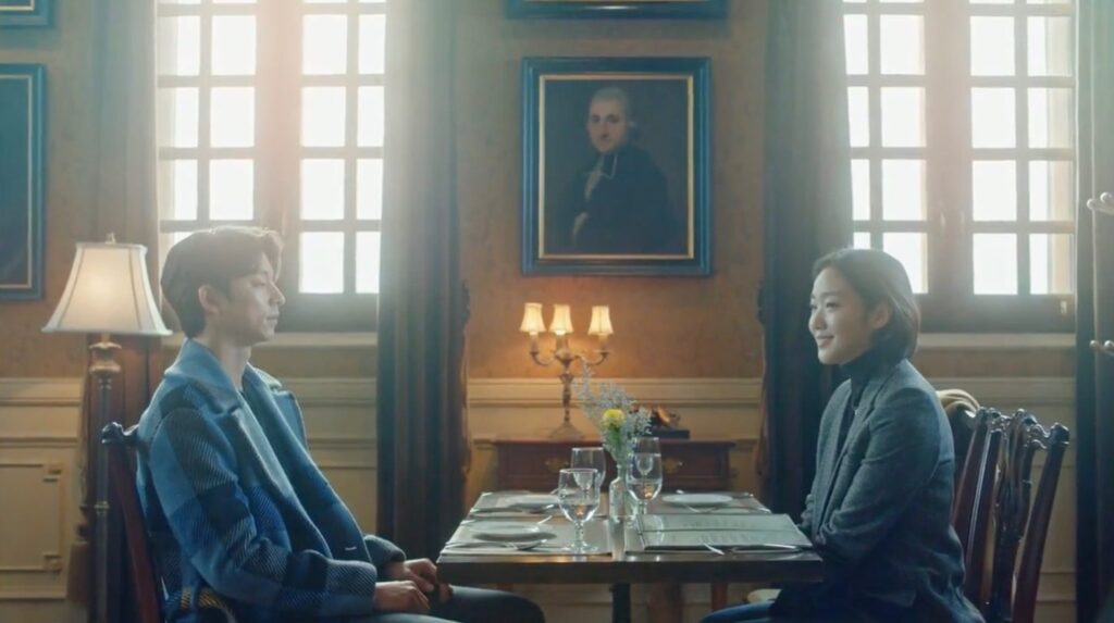 A man and a woman sitting face to face across a dining table.